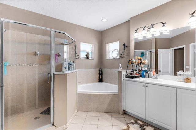 bathroom featuring tile patterned flooring, shower with separate bathtub, and vanity