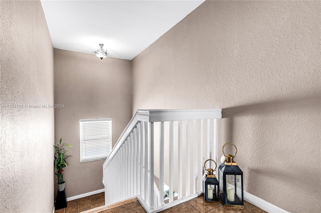 stairway featuring tile patterned flooring