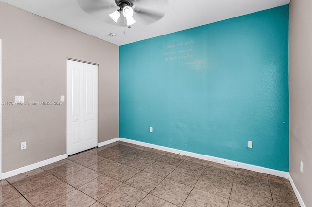 unfurnished bedroom with ceiling fan, a closet, and tile patterned flooring