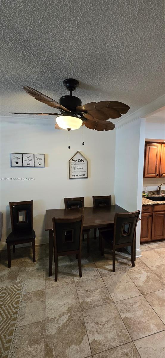 dining room featuring sink and a textured ceiling