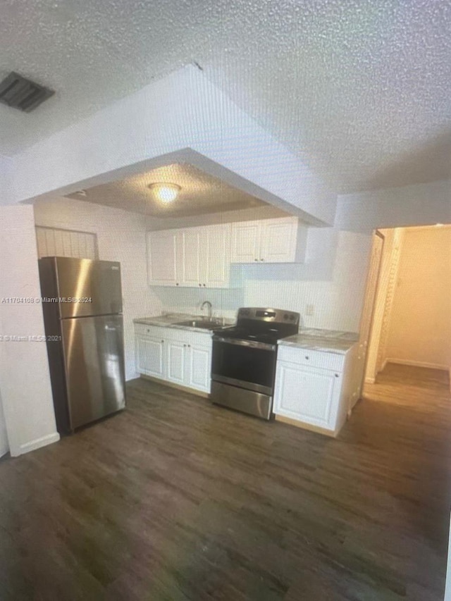 kitchen with white cabinetry, dark hardwood / wood-style flooring, stainless steel appliances, and a textured ceiling