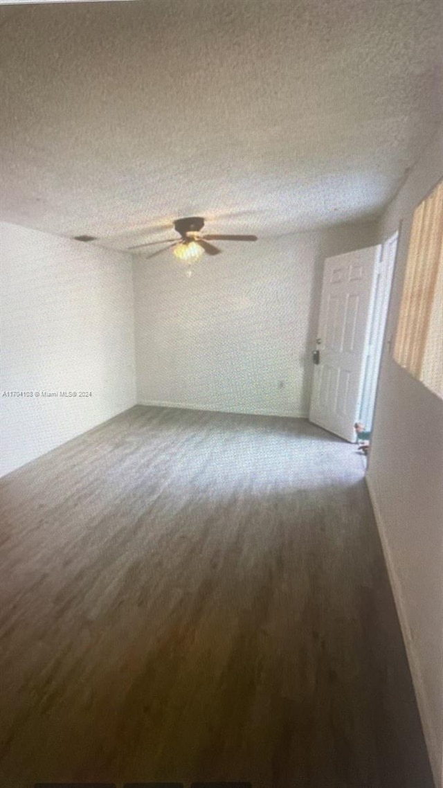 spare room featuring ceiling fan and a textured ceiling