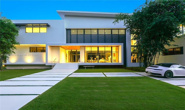 rear view of house with a lawn