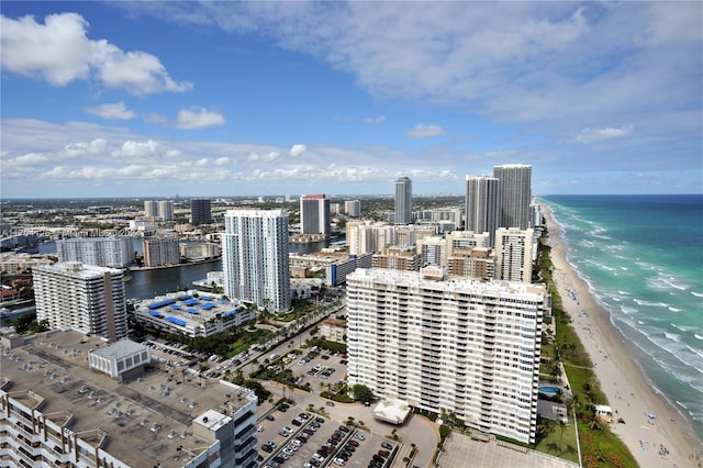 bird's eye view with a water view and a beach view