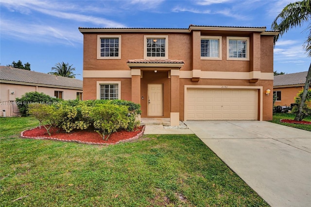 view of front of property with a garage and a front lawn