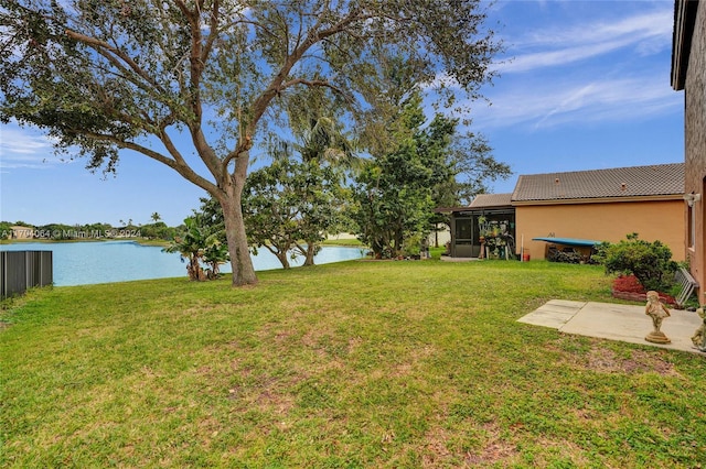 view of yard with a water view and a patio area