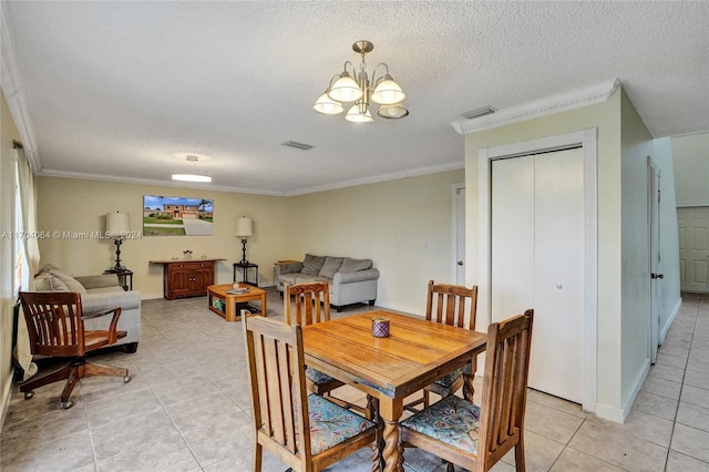 dining area with a textured ceiling, an inviting chandelier, crown molding, and light tile patterned flooring