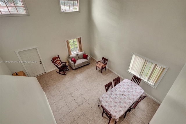 living room featuring a towering ceiling