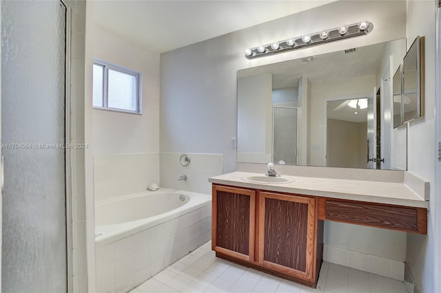 bathroom featuring tile patterned flooring, vanity, and shower with separate bathtub