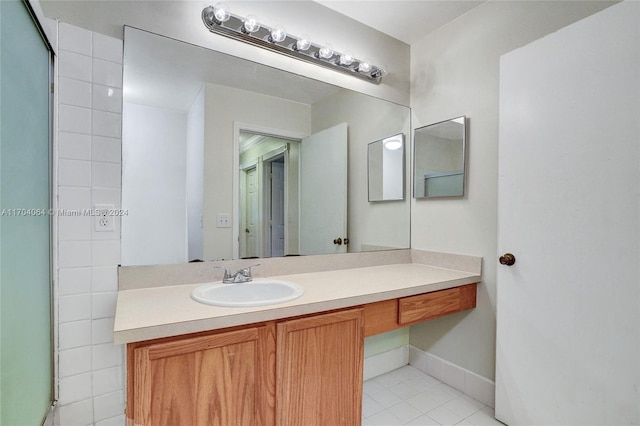 bathroom featuring tile patterned floors, vanity, and tile walls