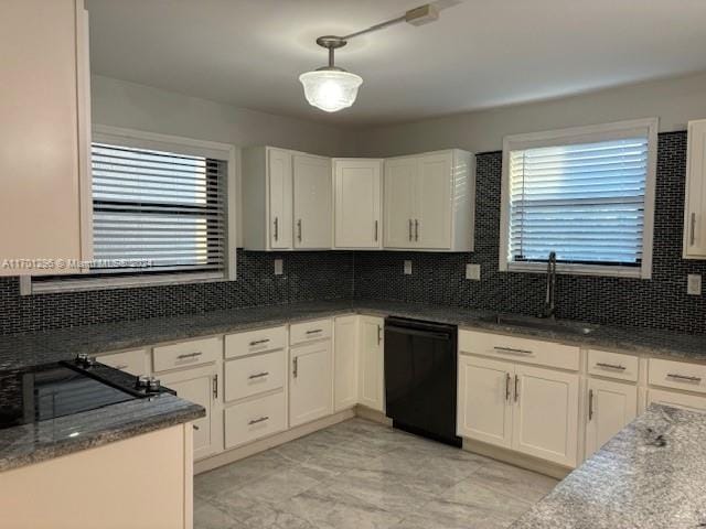 kitchen featuring white cabinetry, dishwasher, sink, hanging light fixtures, and decorative backsplash