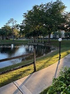 surrounding community with a lawn and a water view