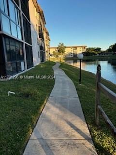 view of property's community featuring a yard and a water view