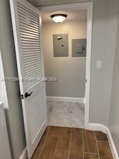 interior space with dark hardwood / wood-style flooring and electric panel