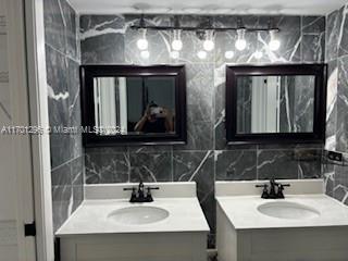 bathroom featuring tasteful backsplash and vanity