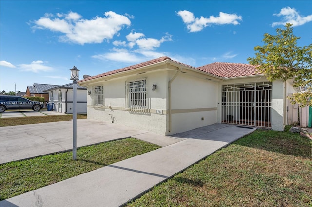 mediterranean / spanish house featuring a front yard