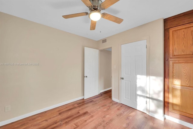 unfurnished bedroom with ceiling fan and light hardwood / wood-style floors