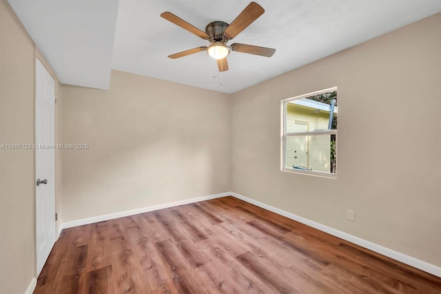 spare room featuring light hardwood / wood-style flooring and ceiling fan