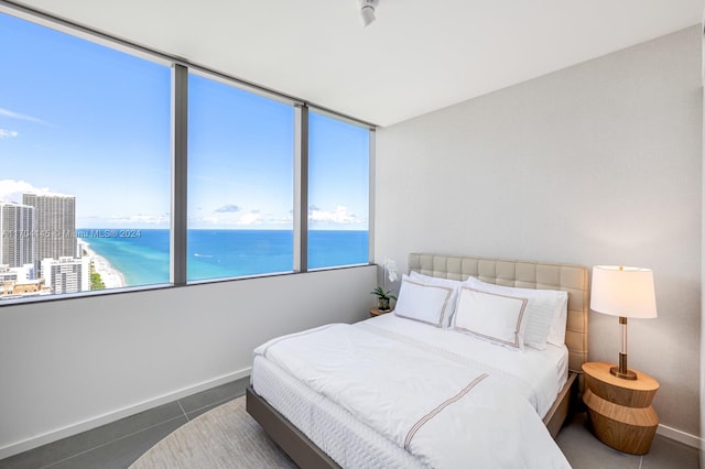 tiled bedroom featuring a water view