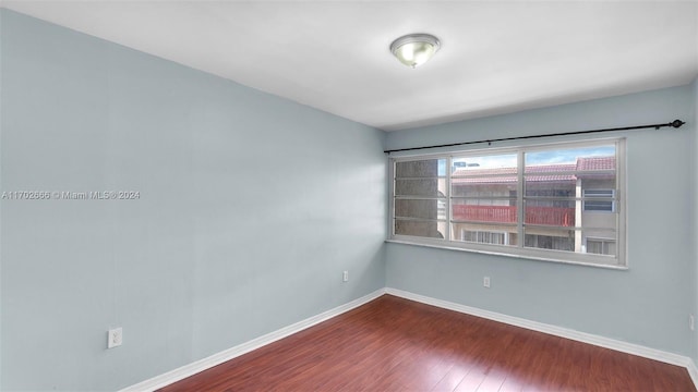 unfurnished room with hardwood / wood-style flooring