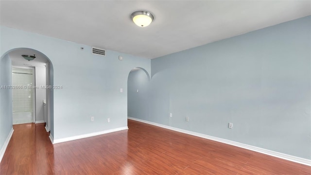 spare room with dark hardwood / wood-style floors