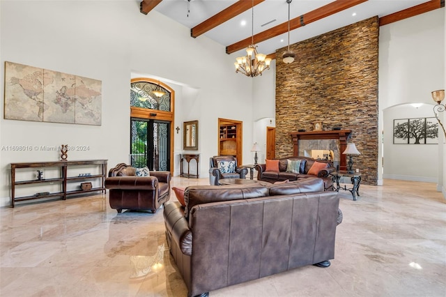 living room featuring beamed ceiling, ceiling fan with notable chandelier, a towering ceiling, and french doors