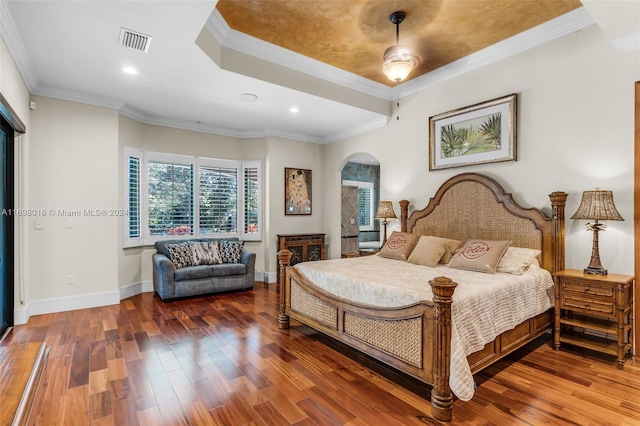 bedroom with ceiling fan, hardwood / wood-style floors, and ornamental molding