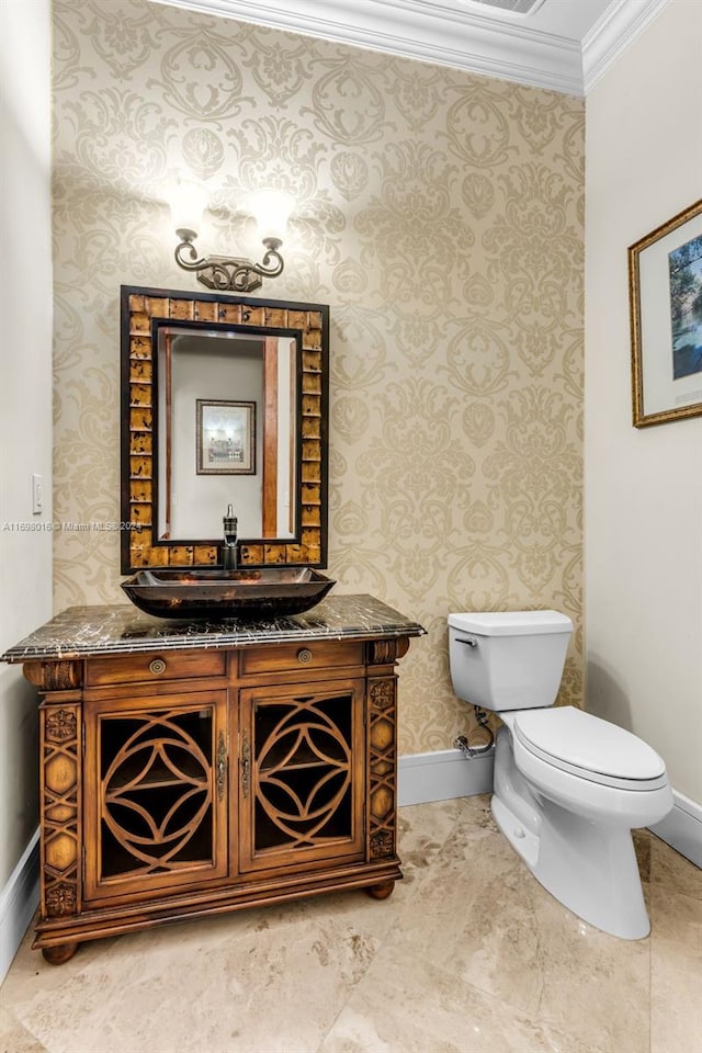 bathroom featuring vanity, toilet, and ornamental molding