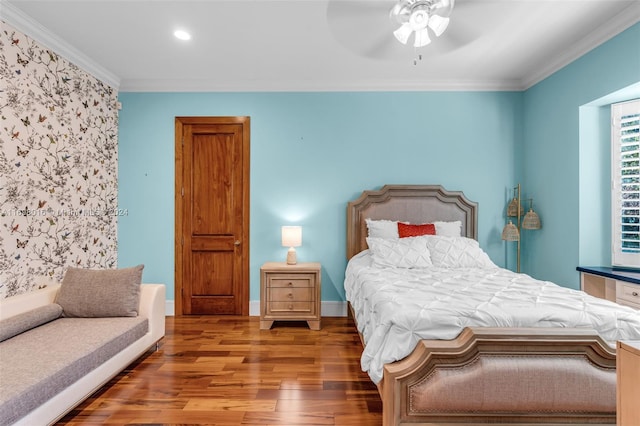 bedroom featuring ceiling fan, crown molding, and wood-type flooring