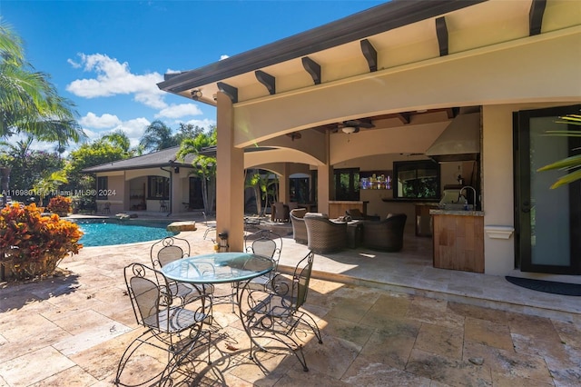 exterior space featuring outdoor lounge area, an outdoor kitchen, ceiling fan, and a patio