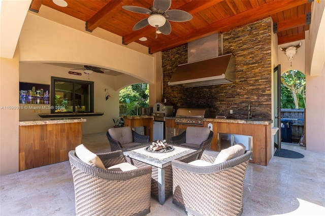 view of patio with area for grilling and ceiling fan