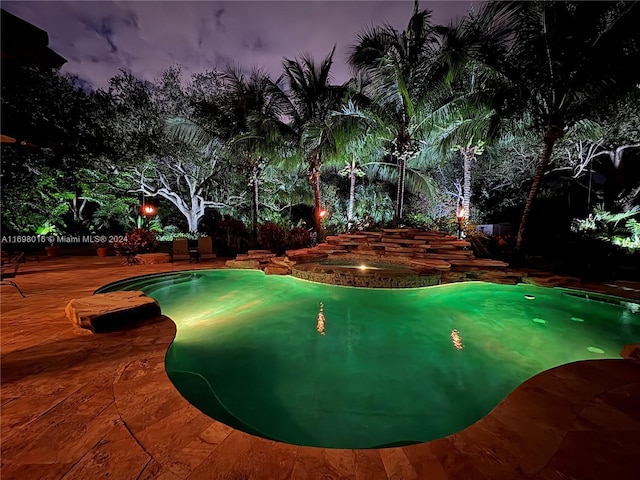 view of pool at dusk