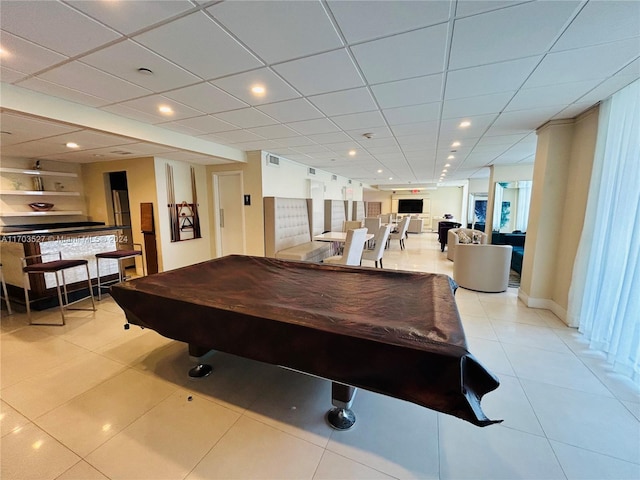 recreation room with light tile patterned flooring, a paneled ceiling, and billiards