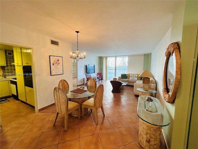 dining room featuring tile patterned flooring and a chandelier