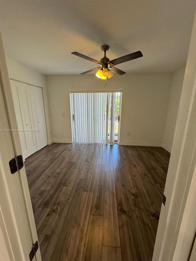 spare room with dark hardwood / wood-style floors, ceiling fan, and a textured ceiling