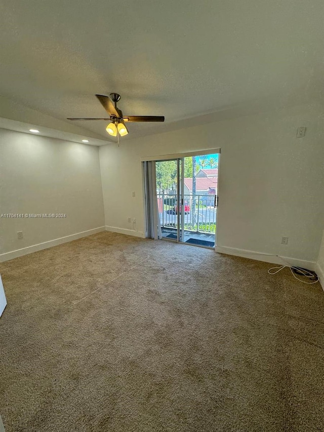 empty room with ceiling fan, carpet floors, and a textured ceiling