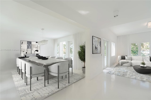 dining space with vaulted ceiling and plenty of natural light