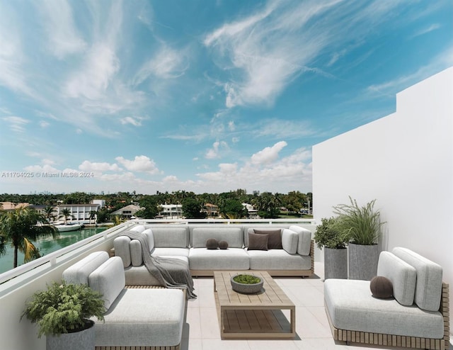 view of patio / terrace with a balcony, a water view, and an outdoor hangout area