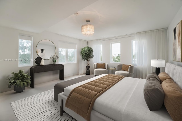 bedroom featuring an inviting chandelier and multiple windows