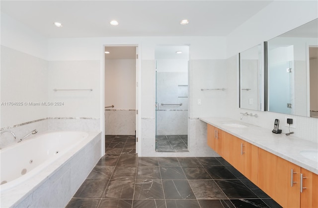 bathroom featuring shower with separate bathtub and vanity