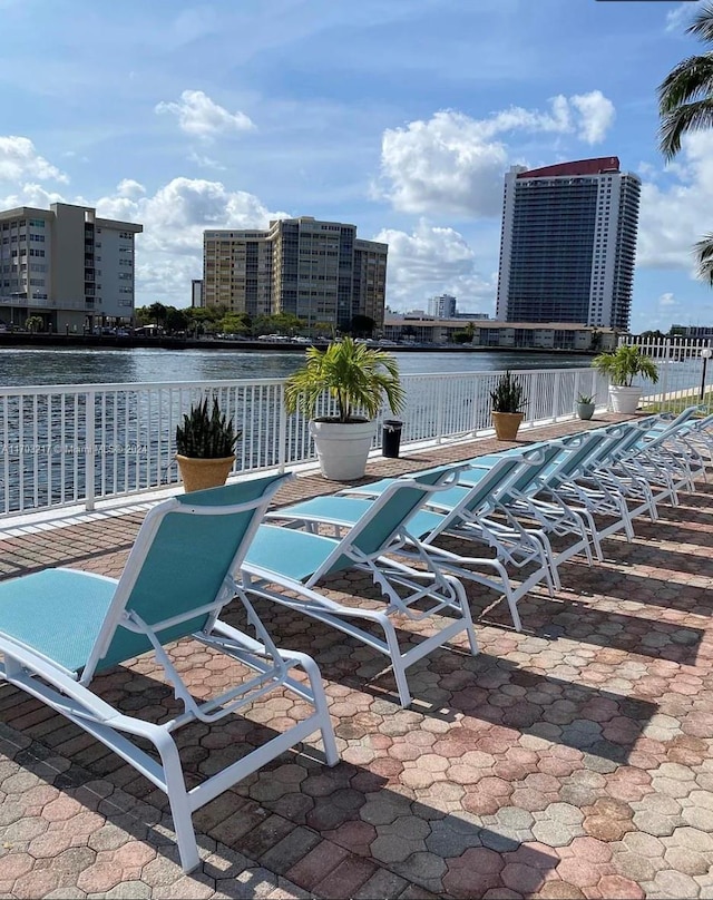 view of pool with a patio and a water view