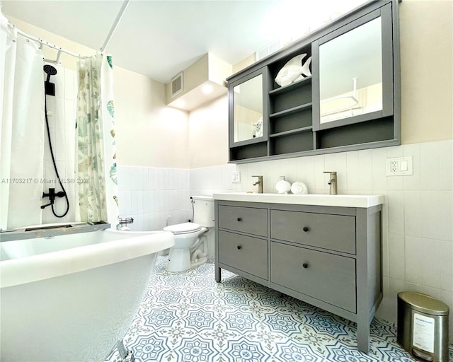 full bathroom with vanity, toilet, and tile walls