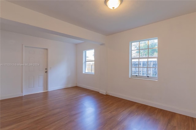 unfurnished room featuring hardwood / wood-style floors and a healthy amount of sunlight