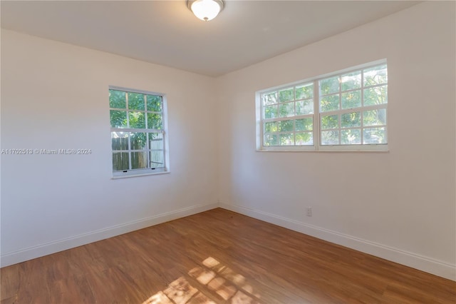 unfurnished room with hardwood / wood-style flooring