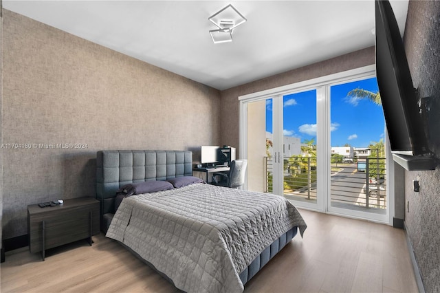 bedroom featuring access to outside and light wood-type flooring