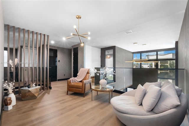 living room with a notable chandelier and light wood-type flooring