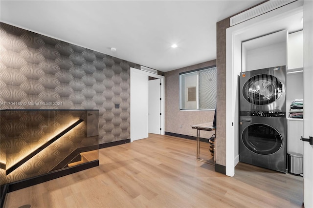 laundry room featuring stacked washer / dryer and light hardwood / wood-style floors