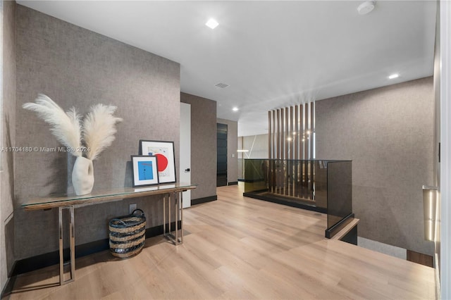 corridor with light hardwood / wood-style flooring