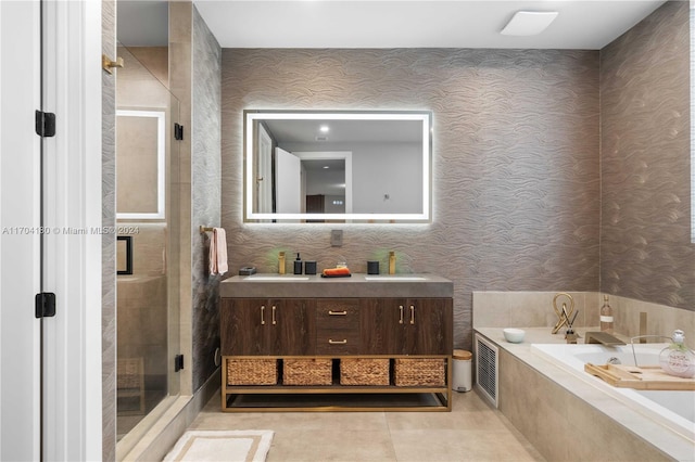 bathroom featuring tile patterned flooring, vanity, and separate shower and tub