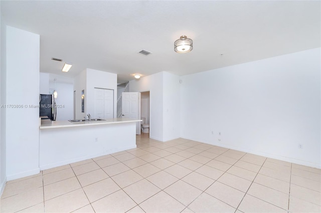 tiled spare room featuring sink